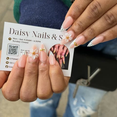 Client with polka-dot French tips and a business card