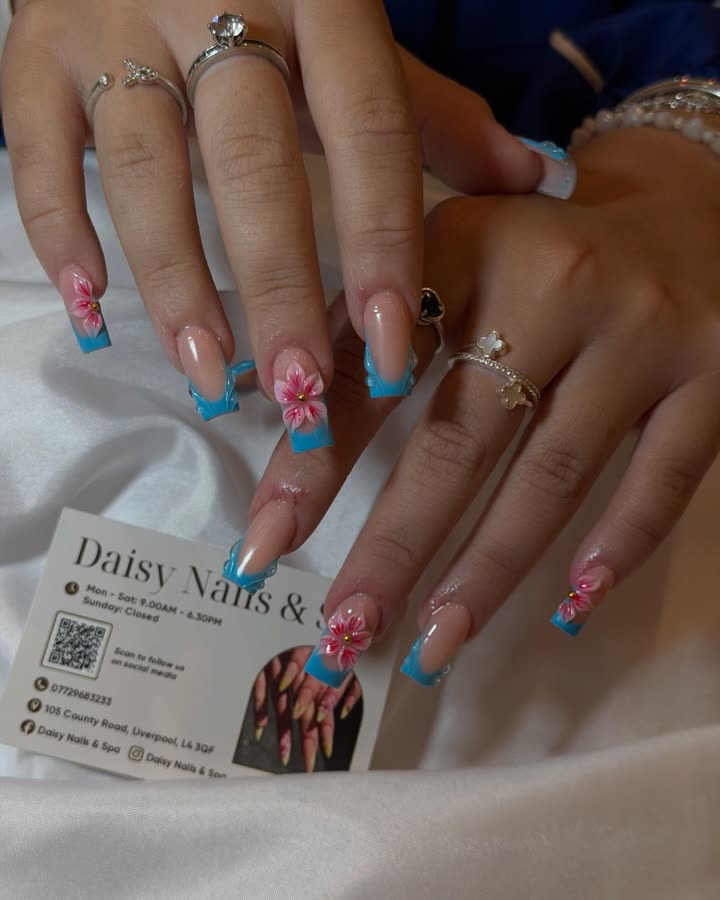 Blue French tips with hand-painted pink flowers