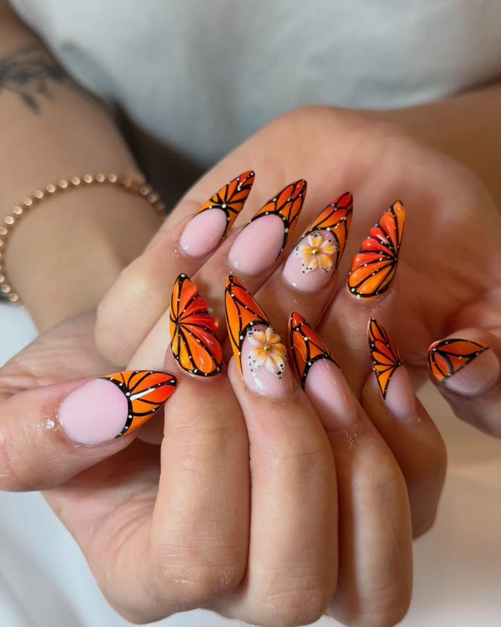 Monarch butterfly wing nail art in orange and black