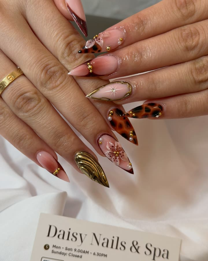 Stiletto nails with leopard-print tips, gold chrome and 3D flowers