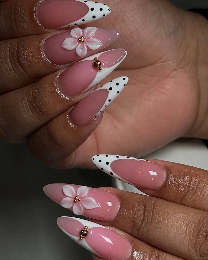 Close-up of polka-dot French tips with 3D pink flowers