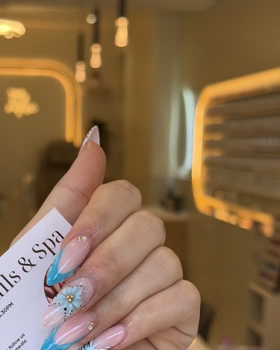 Inside the salon: illuminated arched mirrors and pedicure chairs