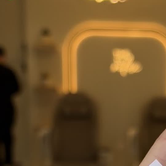 The salon's pedicure chairs beneath an illuminated arched mirror